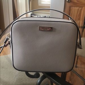 Small, cream colored kate spade purse